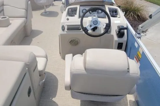 Slide: The Image of 2016 Bennington 21SFX boat interior with beige seating and steering console. - 4