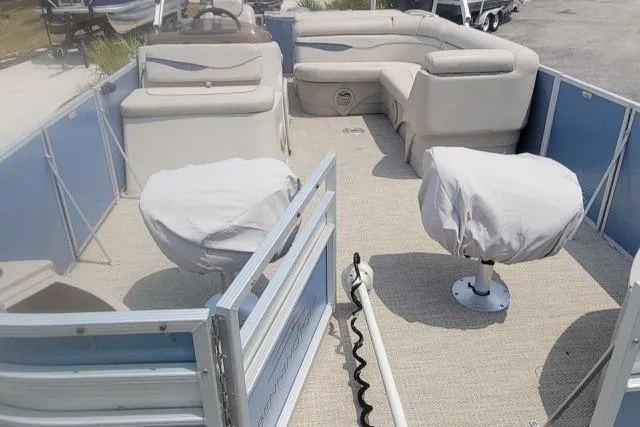 Slide: The Image of 2016 Bennington 21SFX pontoon boat interior with covered seats and spacious layout. - 6