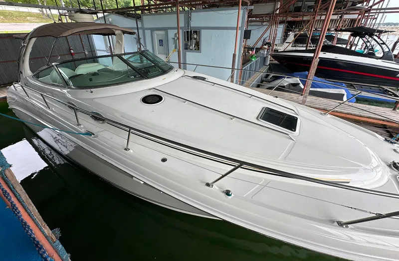 Slide: The Image of 2002 Sea Ray 360 Sundancer yacht docked in a marina, showcasing sleek design and spacious deck. - 12