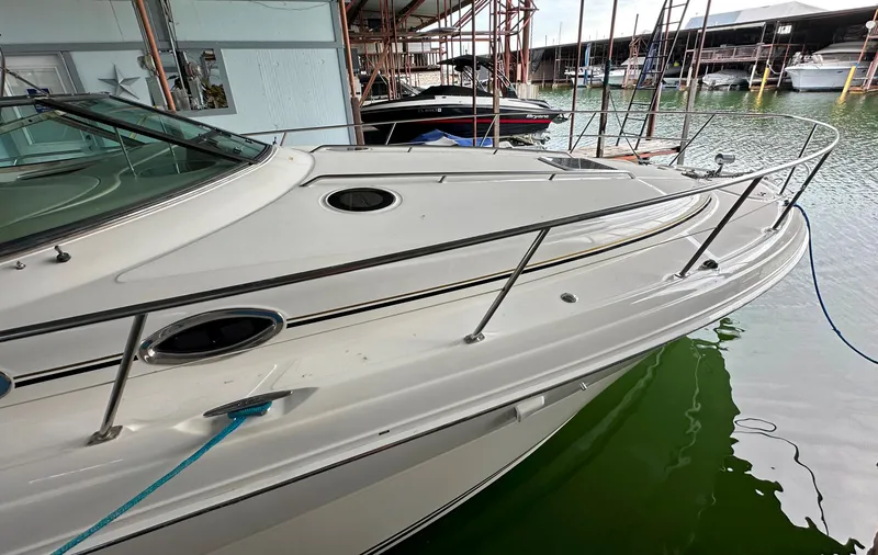 Slide: The Image of 2002 Sea Ray 360 Sundancer docked in marina, showcasing sleek design and spacious deck. - 15