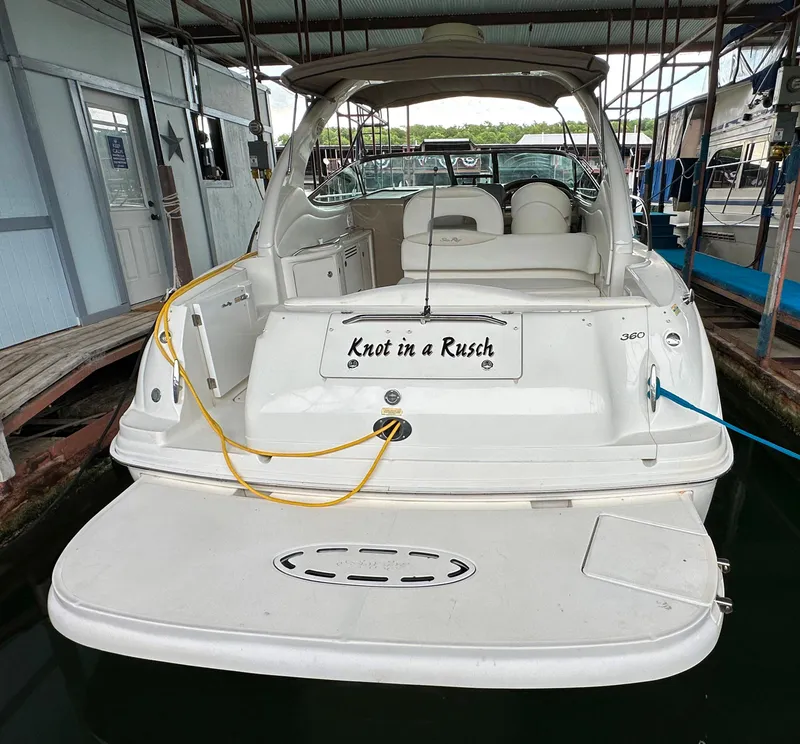 Slide: The Image of 2002 Sea Ray 360 Sundancer docked, rear view with "Knot in a Rusch" nameplate. - 16