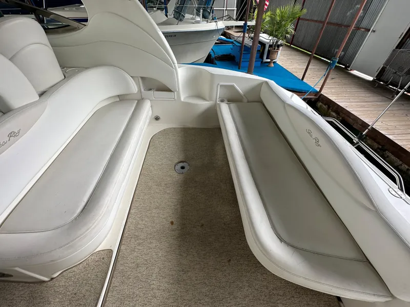 Slide: The Image of 2002 Sea Ray 360 Sundancer interior with white seating and carpeted floor. - 17