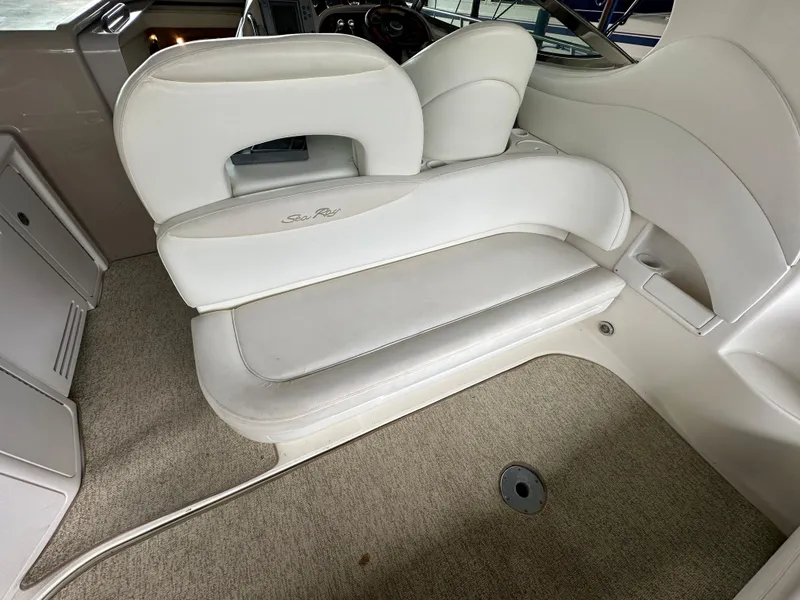 Slide: The Image of 2002 Sea Ray 360 Sundancer interior with white seating and carpeted flooring. - 19