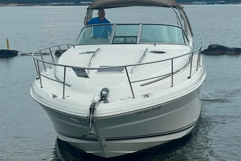 Slide: The Image of 2002 Sea Ray 360 Sundancer boat on water, front view, with "For Sale" sign. - 2