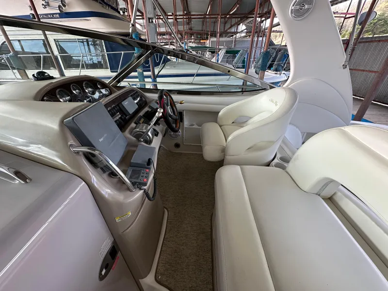 Slide: The Image of 2002 Sea Ray 360 Sundancer helm with modern controls and comfortable seating. - 21