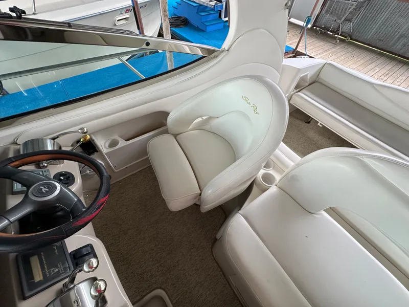 Slide: The Image of 2002 Sea Ray 360 Sundancer interior with helm, seating, and steering wheel. - 23