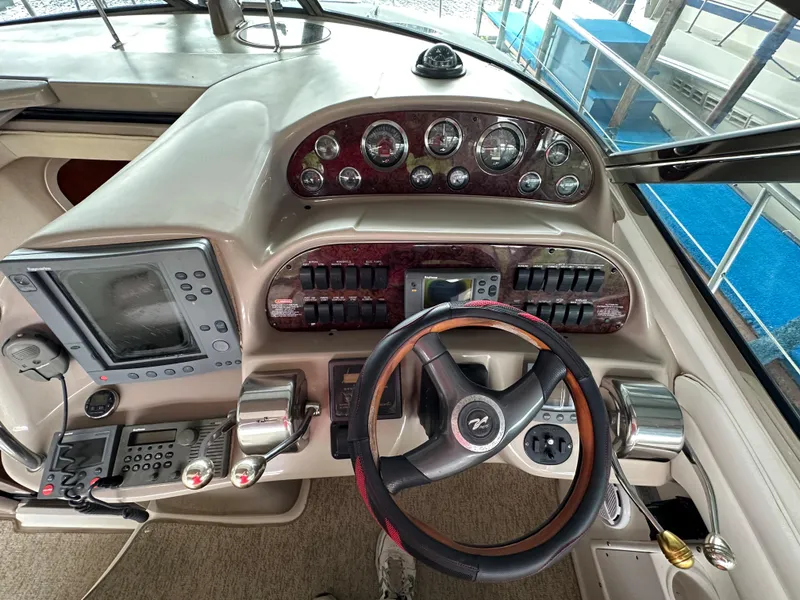 Slide: The Image of Cockpit of 2002 Sea Ray 360 Sundancer with steering wheel and control panel. - 25