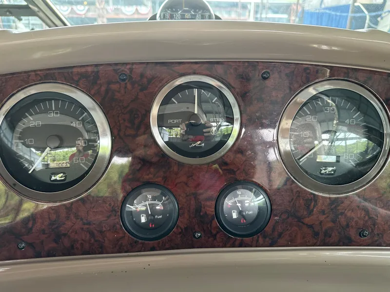 Slide: The Image of Dashboard of a 2002 Sea Ray 360 Sundancer boat with gauges and controls. - 29