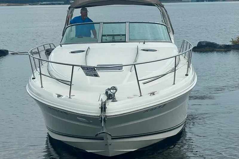 Slide: The Image of 2002 Sea Ray 360 Sundancer boat on water, front view, with "For Sale" sign. - 3