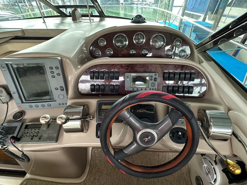 Slide: The Image of Control panel of a 2002 Sea Ray 360 Sundancer boat with steering wheel and gauges. - 31