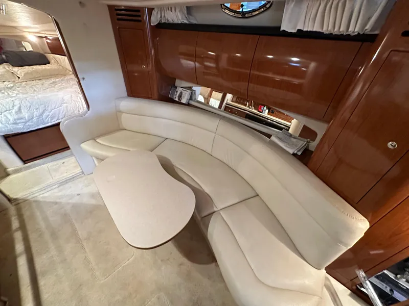 Slide: The Image of 2002 Sea Ray 360 Sundancer interior with curved seating and table. - 35