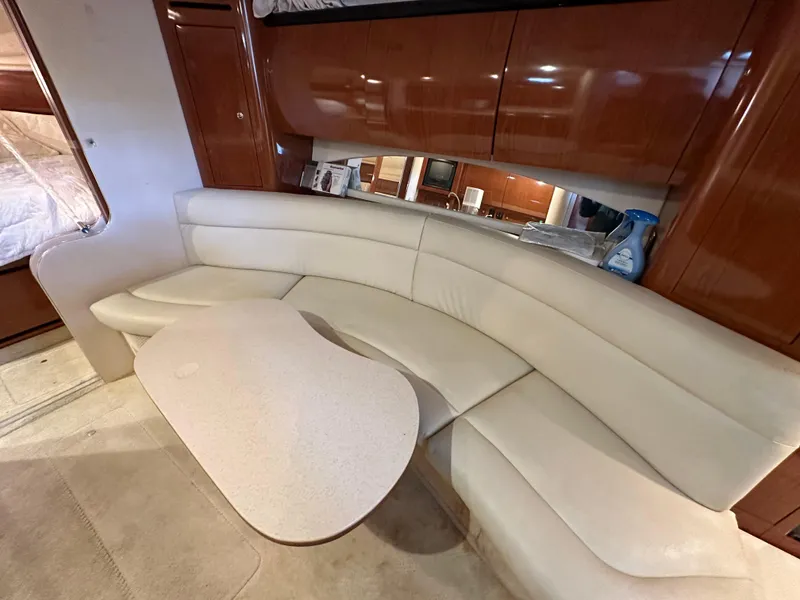 Slide: The Image of 2002 Sea Ray 360 Sundancer interior with cream leather seating and wooden cabinetry. - 38