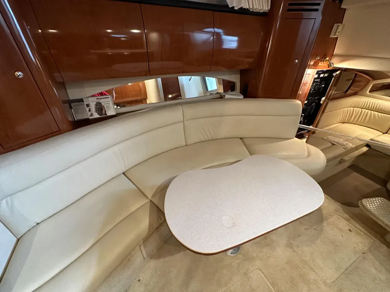 Slide: The Image of Luxurious interior of 2002 Sea Ray 360 Sundancer with cream leather seating and wooden accents. - 39