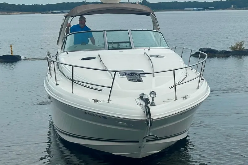 Slide: The Image of 2002 Sea Ray 360 Sundancer boat on water, for sale sign visible. - 4