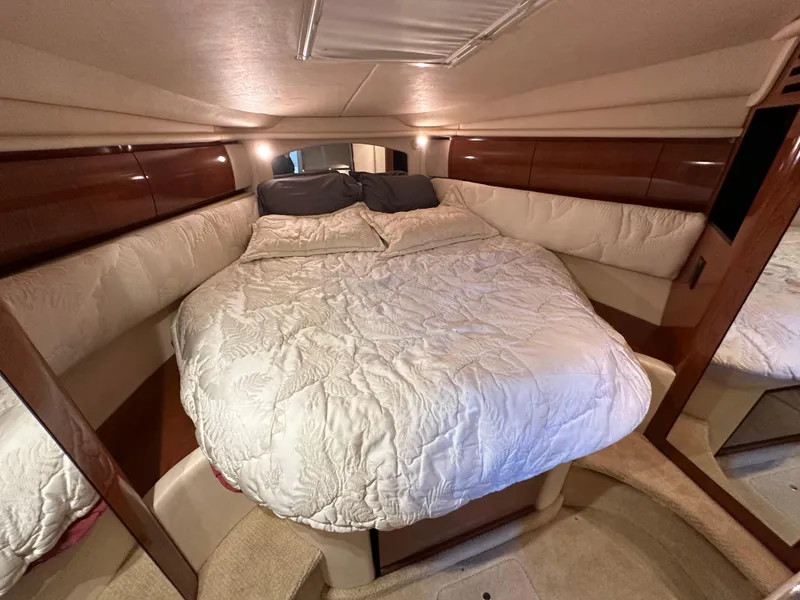 Slide: The Image of Luxurious cabin interior of 2002 Sea Ray 360 Sundancer with cozy bed and elegant wood finish. - 41