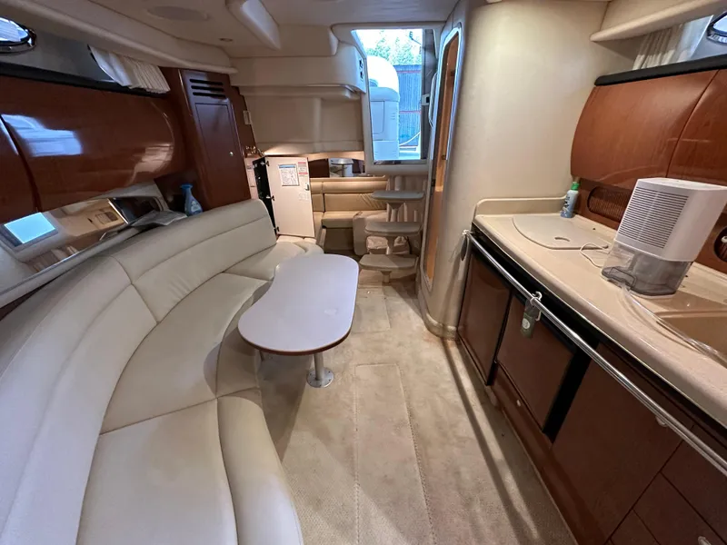 Slide: The Image of Luxurious interior of 2002 Sea Ray 360 Sundancer yacht with elegant seating and kitchenette. - 44