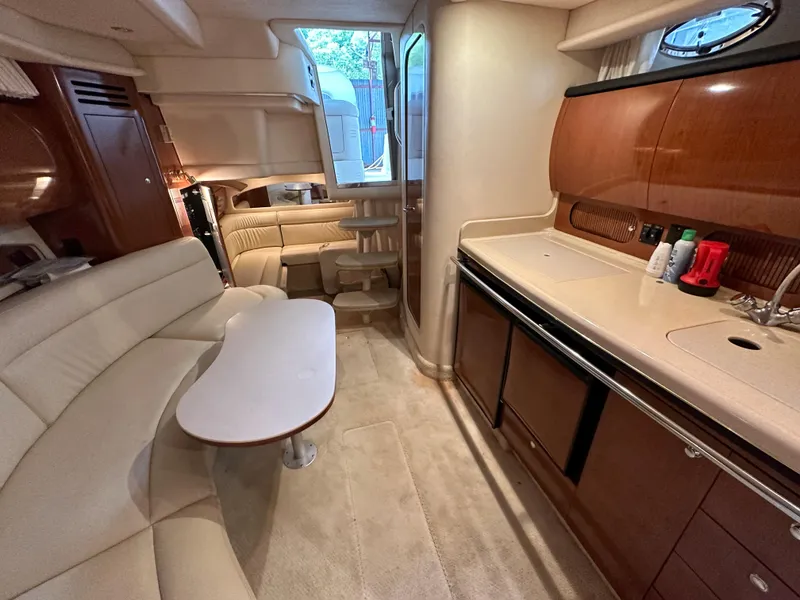Slide: The Image of 2002 Sea Ray 360 Sundancer interior with kitchen, seating, and modern amenities. - 45