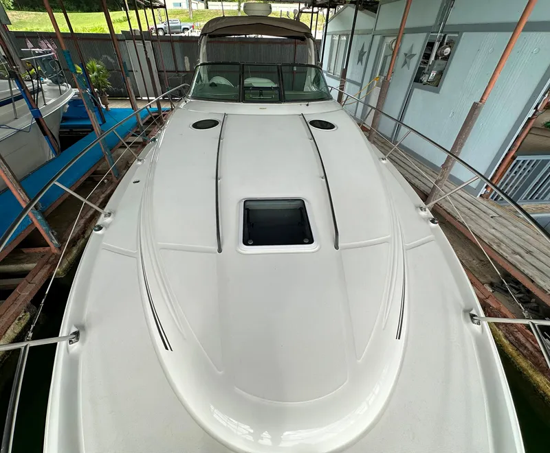 Slide: The Image of 2002 Sea Ray 360 Sundancer yacht docked, showcasing sleek deck design and spacious layout. - 49