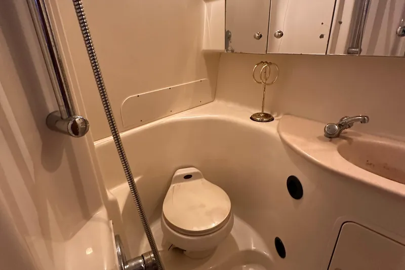 Slide: The Image of 2002 Sea Ray 360 Sundancer bathroom with toilet, sink, and shower fixtures. - 51