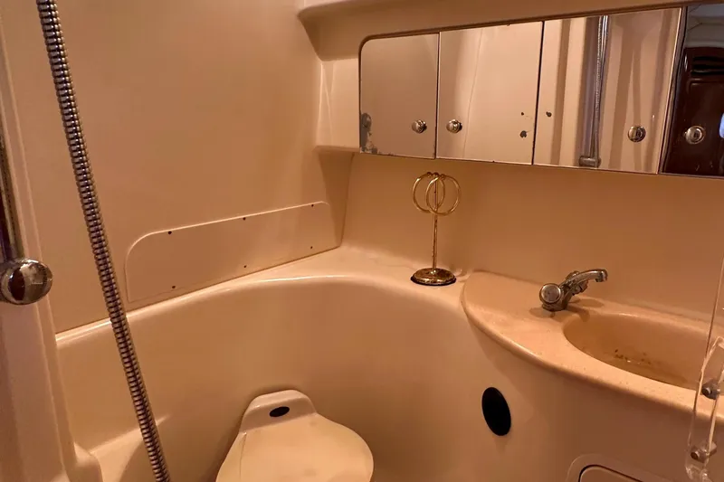 Slide: The Image of 2002 Sea Ray 360 Sundancer bathroom with sink, mirror, and showerhead. - 53