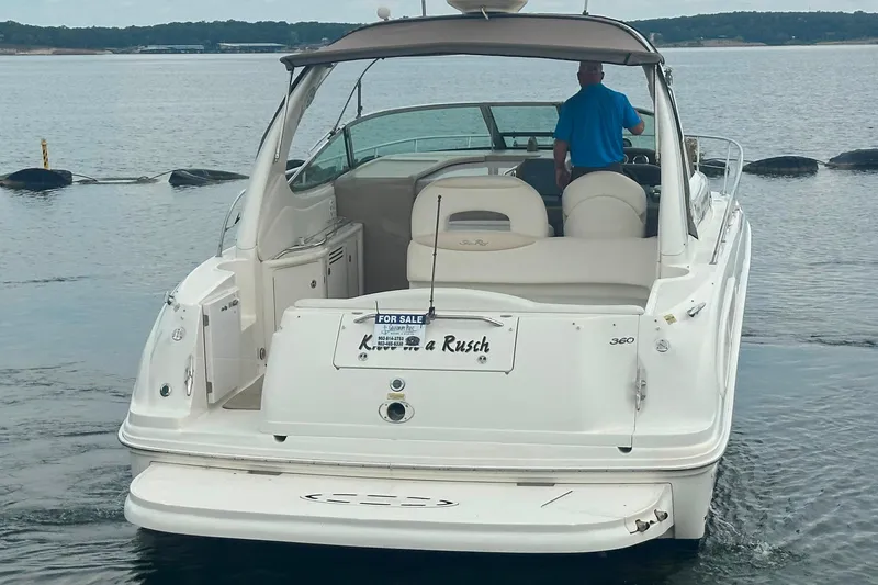 Slide: The Image of 2002 Sea Ray 360 Sundancer boat on water, rear view, with "For Sale" sign. - 9
