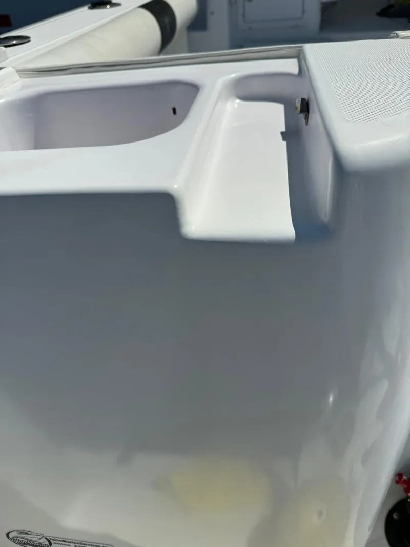 Slide: The Image of 2005 Pro-Line 32 Express boat detail, featuring white fiberglass structure and storage compartment. - 11