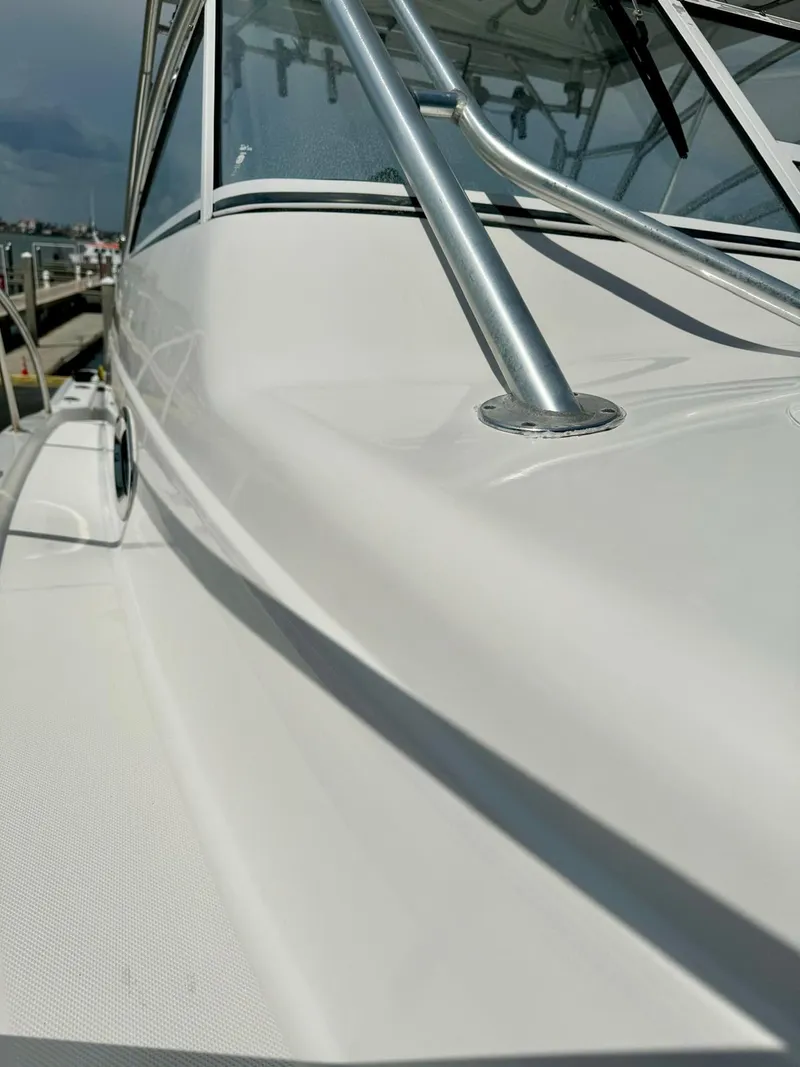 Slide: The Image of 2005 Pro-Line 32 Express boat, sleek white exterior, docked at marina. - 14