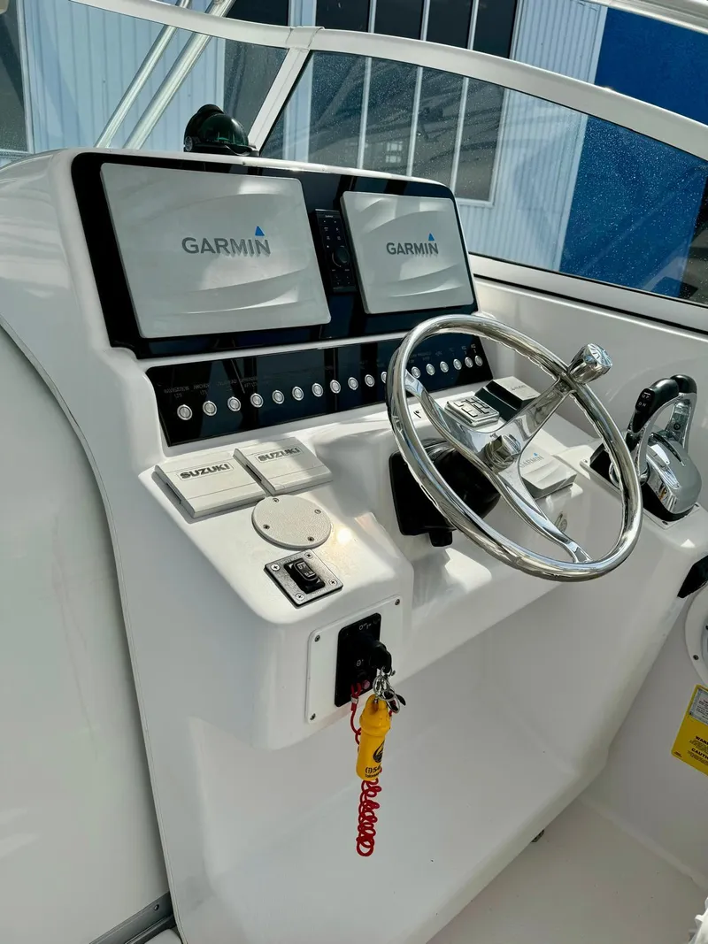 Slide: The Image of 2005 Pro-Line 32 Express helm with Garmin navigation displays and steering wheel. - 18