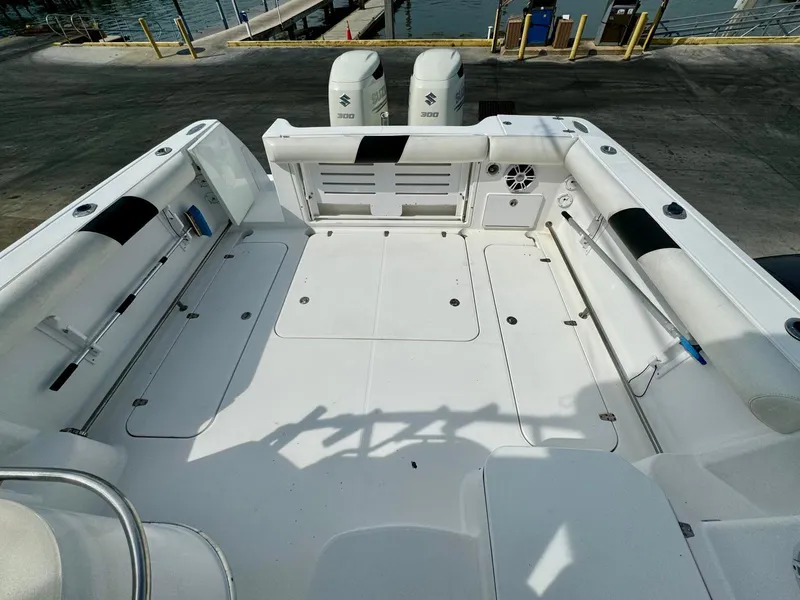 Slide: The Image of 2005 Pro-Line 32 Express boat deck with twin Suzuki engines at dock. - 5