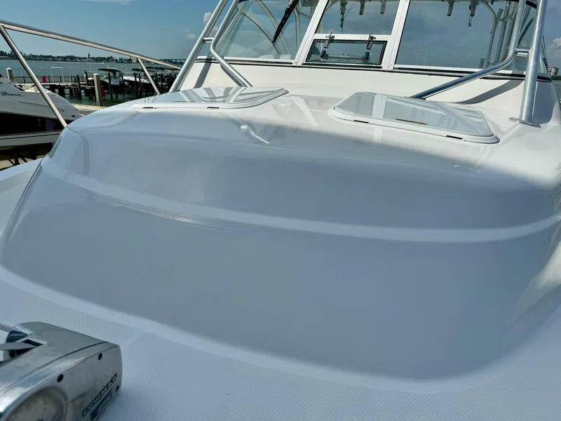 Slide: The Image of 2005 Pro-Line 32 Express boat deck with hatches and railing, dockside view. - 6