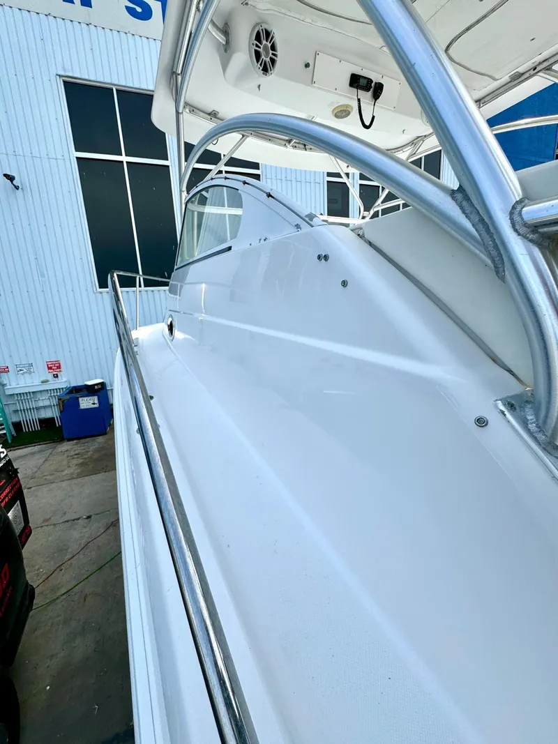 Slide: The Image of 2005 Pro-Line 32 Express boat with sleek white deck and stainless steel railings. - 7