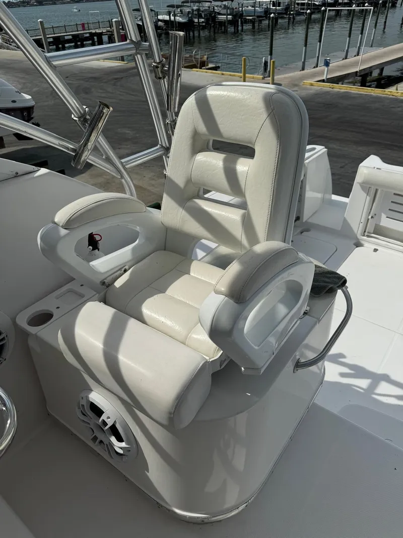 Slide: The Image of 2005 Pro-Line 32 Express boat captain's chair with armrests and cup holder, dockside view. - 8