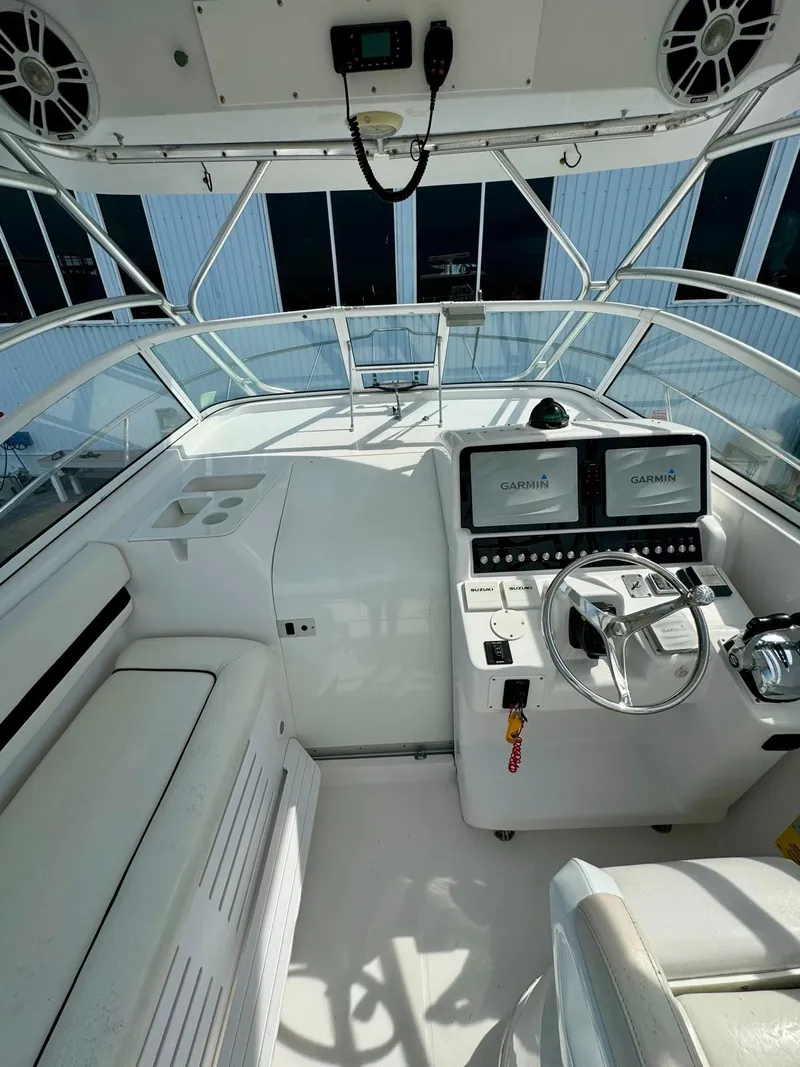 Slide: The Image of 2005 Pro-Line 32 Express boat cockpit with steering wheel and navigation screens. - 9