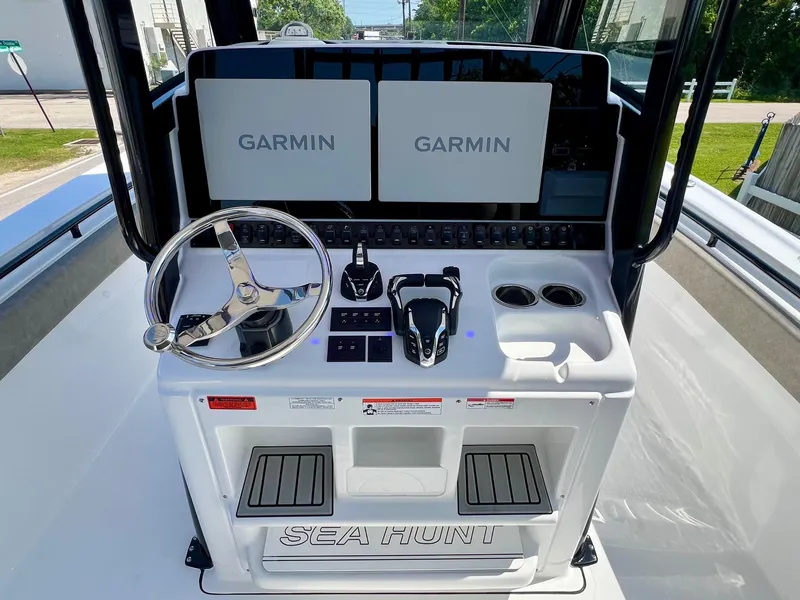 Slide: The Image of 2025 Sea Hunt Gamefish 30 helm with dual Garmin displays and steering wheel. - 11