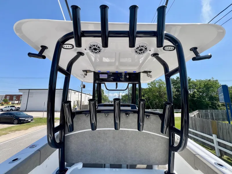 Slide: The Image of 2025 Sea Hunt Gamefish 30 boat with T-top and rod holders, viewed from the rear. - 12