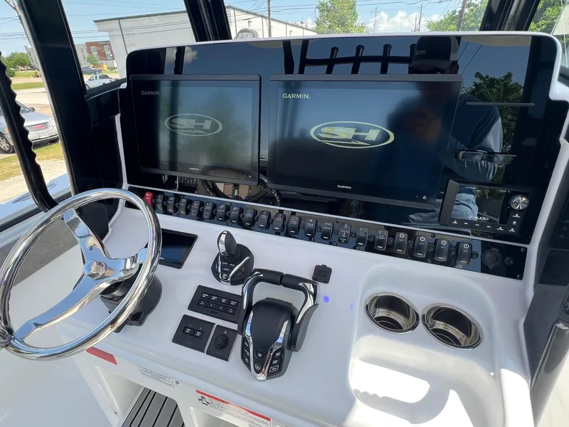 Slide: The Image of 2025 Sea Hunt Gamefish 30 helm with dual Garmin displays and modern controls. - 17