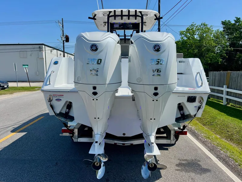 Slide: The Image of 2025 Sea Hunt Gamefish 30 with twin outboard engines, parked on a street. - 3