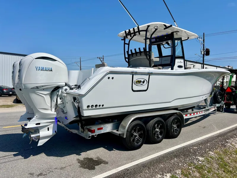 Slide: The Image of 2025 Sea Hunt Gamefish 30 with Coffin Box on trailer, featuring Yamaha engines. - 4