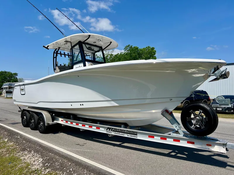 Slide: The Image of 2025 Sea Hunt Gamefish 30 with Coffin Box on trailer, parked on roadside. - 5