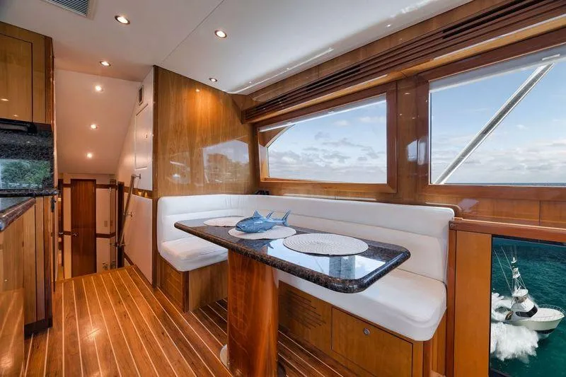Slide: The Image of Luxurious interior of 2009 Hatteras 60GT yacht with elegant wood finish and ocean view. - 12