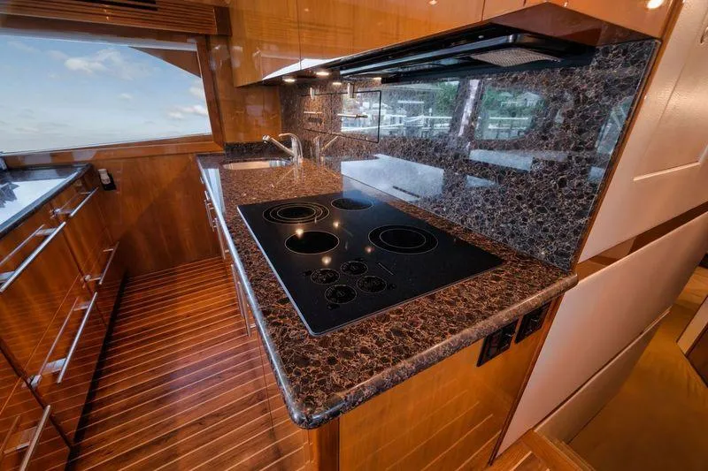 Slide: The Image of Luxurious kitchen interior of 2009 Hatteras 60GT yacht with marble countertops and modern appliances. - 14