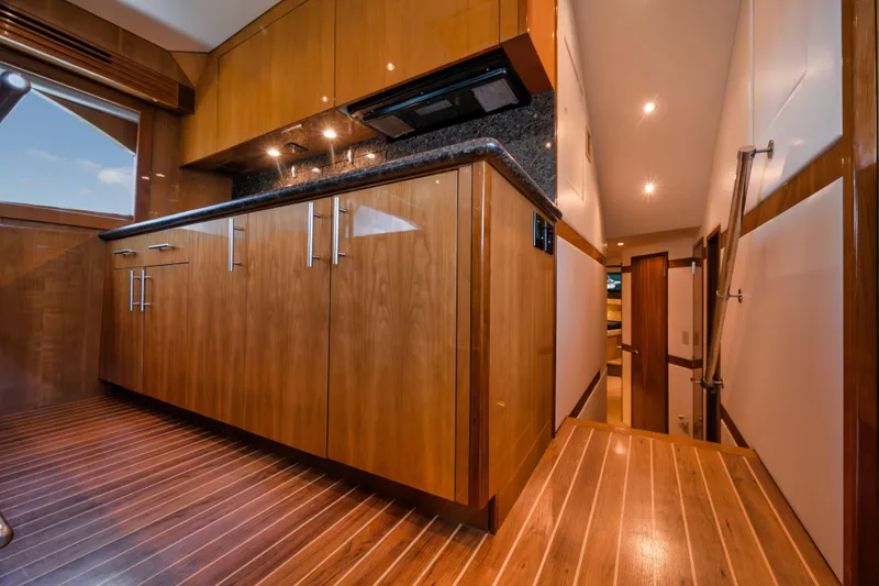 Slide: The Image of Luxurious wooden interior of 2009 Hatteras 60GT yacht kitchen with modern cabinetry. - 15