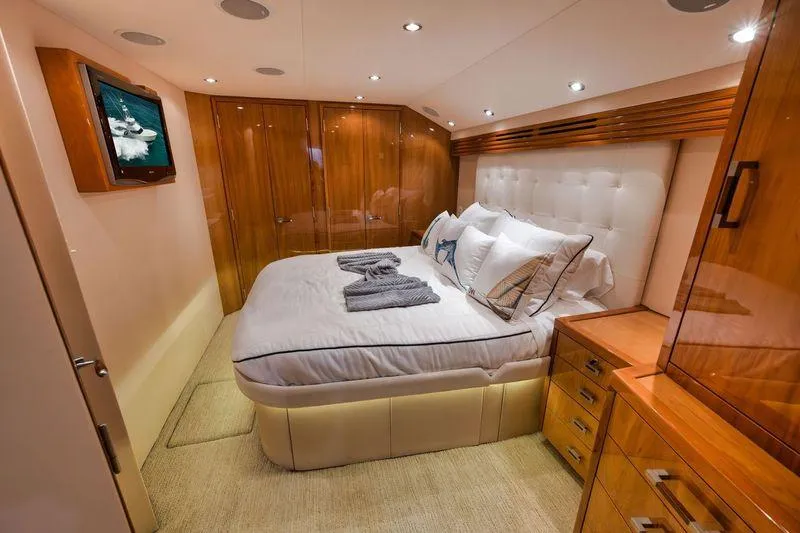 Slide: The Image of Luxurious bedroom interior of 2009 Hatteras 60GT yacht with wood finishes and cozy bedding. - 17