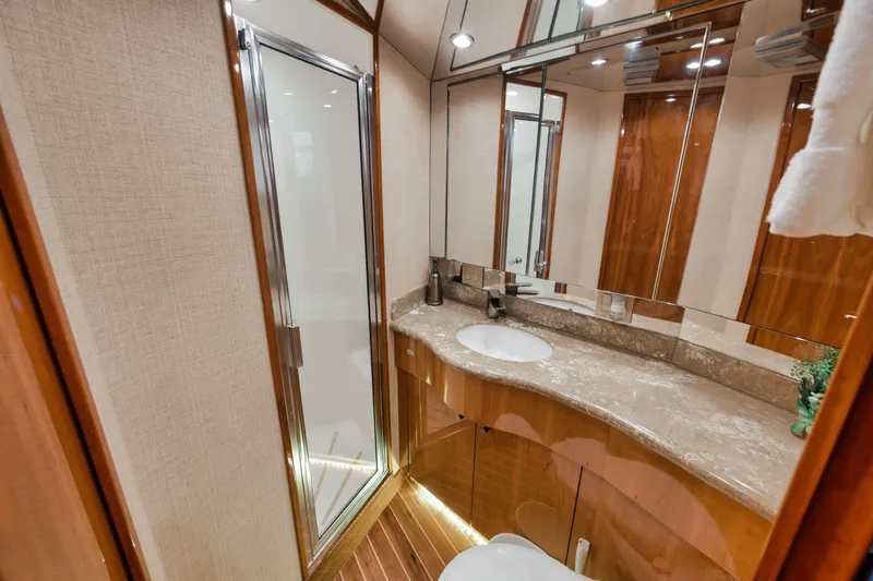 Slide: The Image of Luxurious bathroom in 2009 Hatteras 60GT yacht with modern fixtures and elegant wood accents. - 19