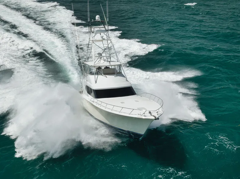 Slide: The Image of Hatteras 60GT 2009 yacht cruising swiftly on turquoise ocean waters. - 3