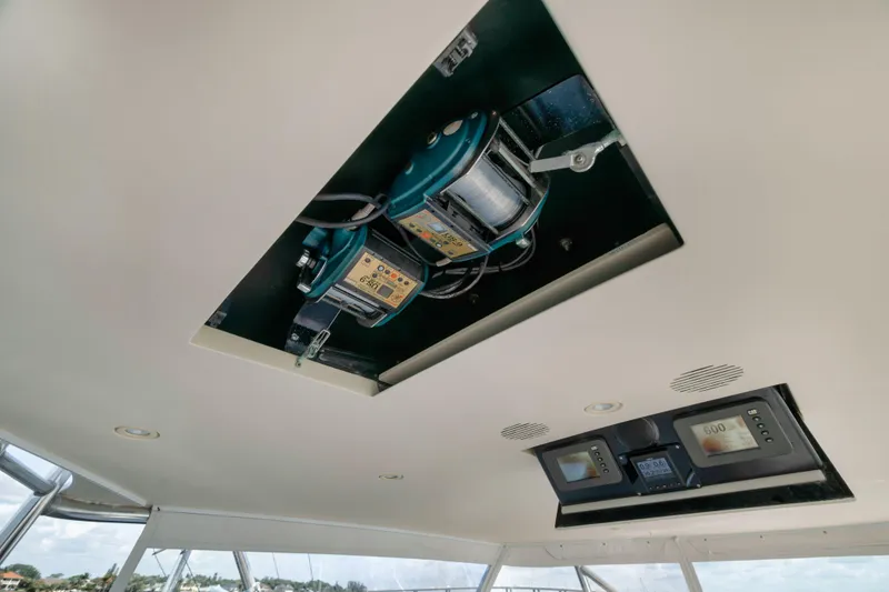 Slide: The Image of Ceiling view of 2009 Hatteras 60GT yacht with electronic equipment and control panels. - 32