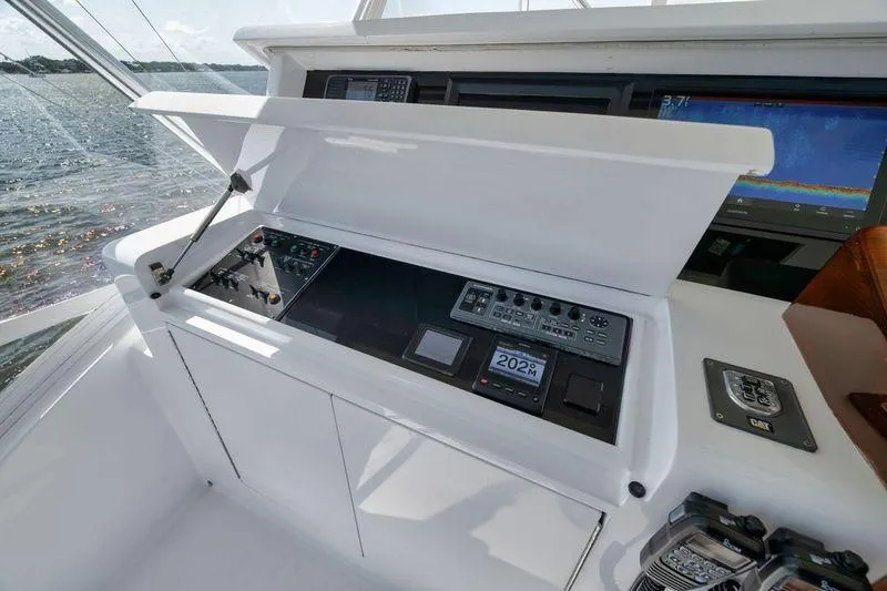 Slide: The Image of Control panel of a 2009 Hatteras 60GT yacht, featuring navigation and communication equipment. - 34