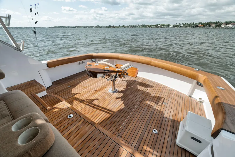 Slide: The Image of Spacious deck of 2009 Hatteras 60GT yacht with wooden flooring and fishing chair. - 38