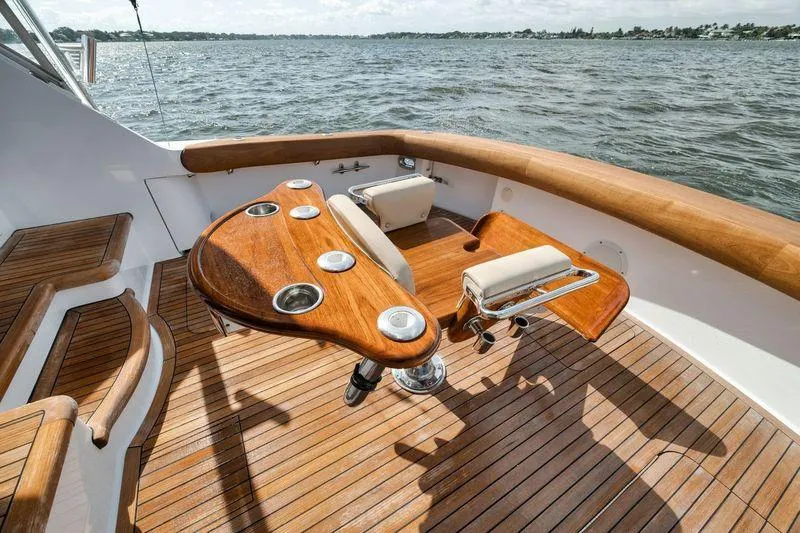 Slide: The Image of 2009 Hatteras 60GT yacht deck with wooden seating and ocean view. - 39