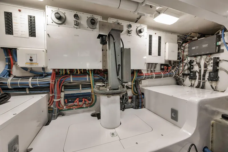 Slide: The Image of Engine room of 2009 Hatteras 60GT yacht with control panels and wiring. - 42